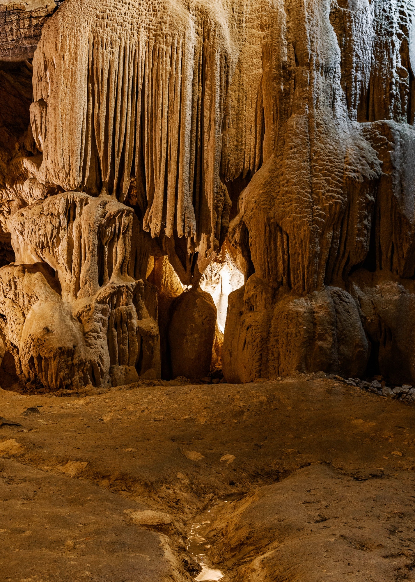 Formations inside cave with stalactites and stalagmites. Karst underground cave.