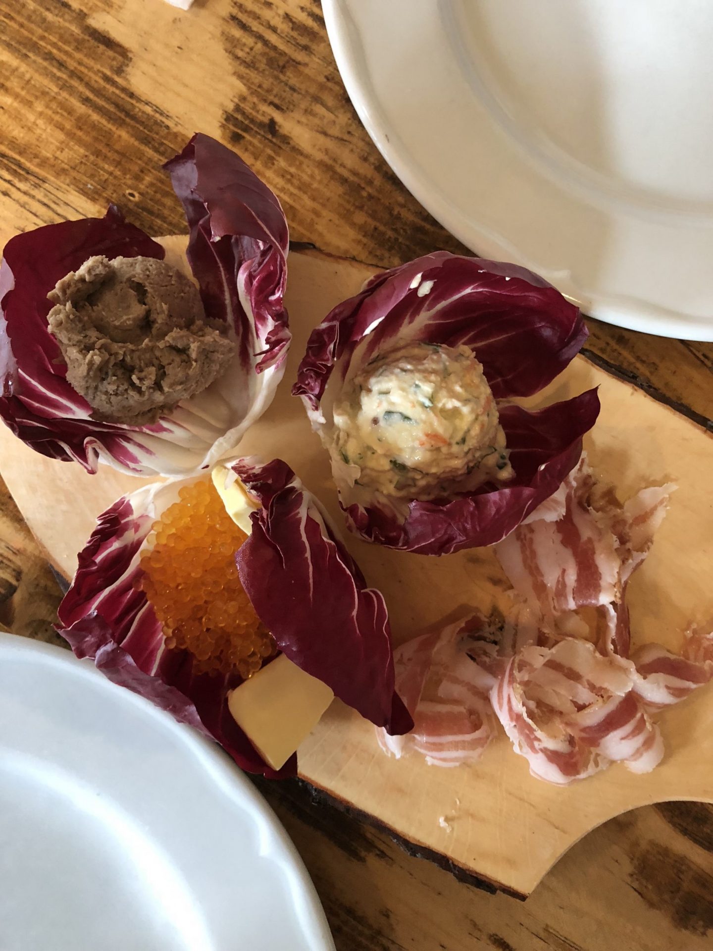 plate with pate, roe, french salad, and salami