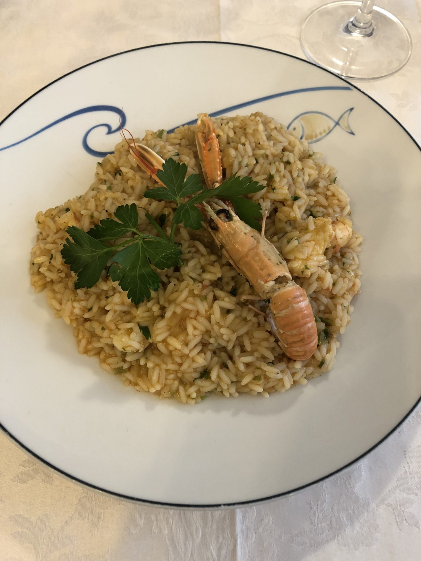 Risotto served with a whole unshelled shrimp
