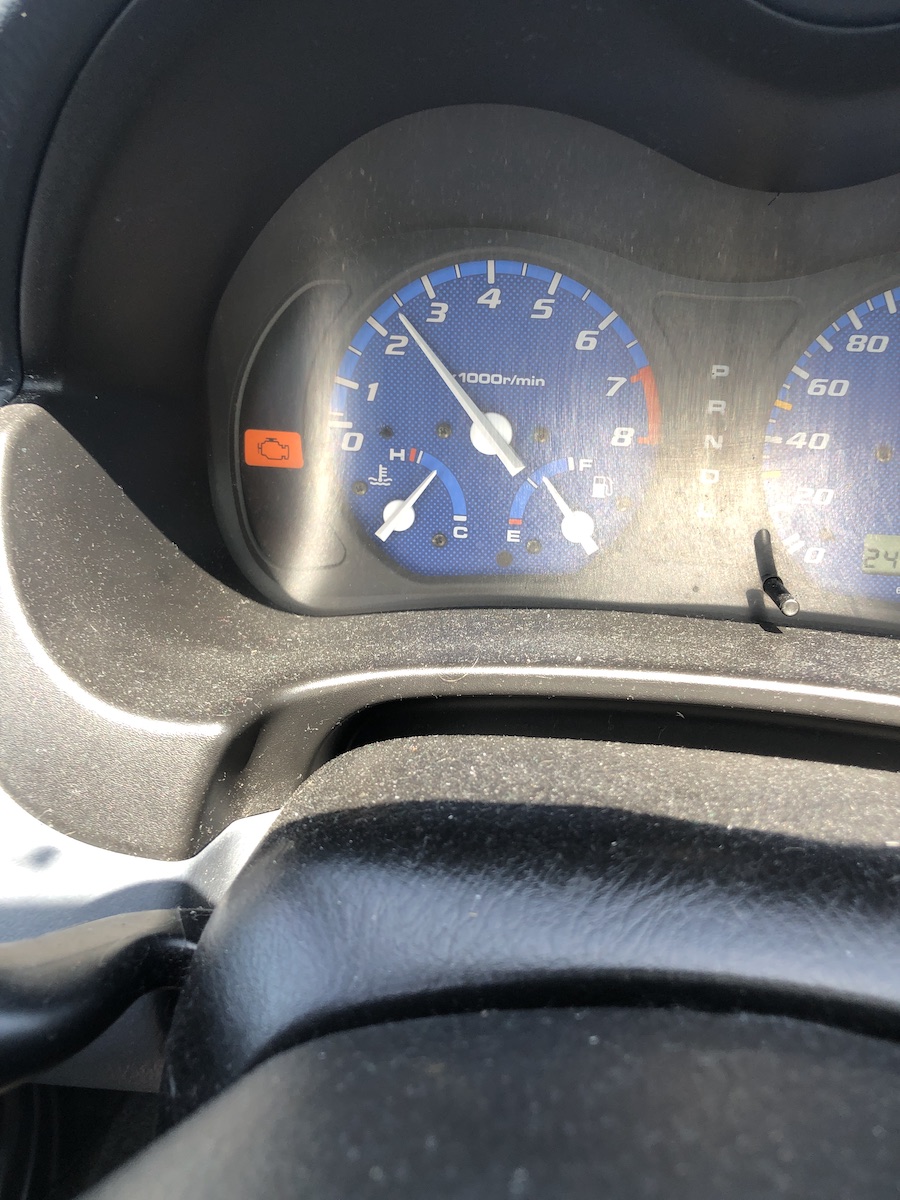the dashboard of my car showing the temperature gauge almost all the way to hot