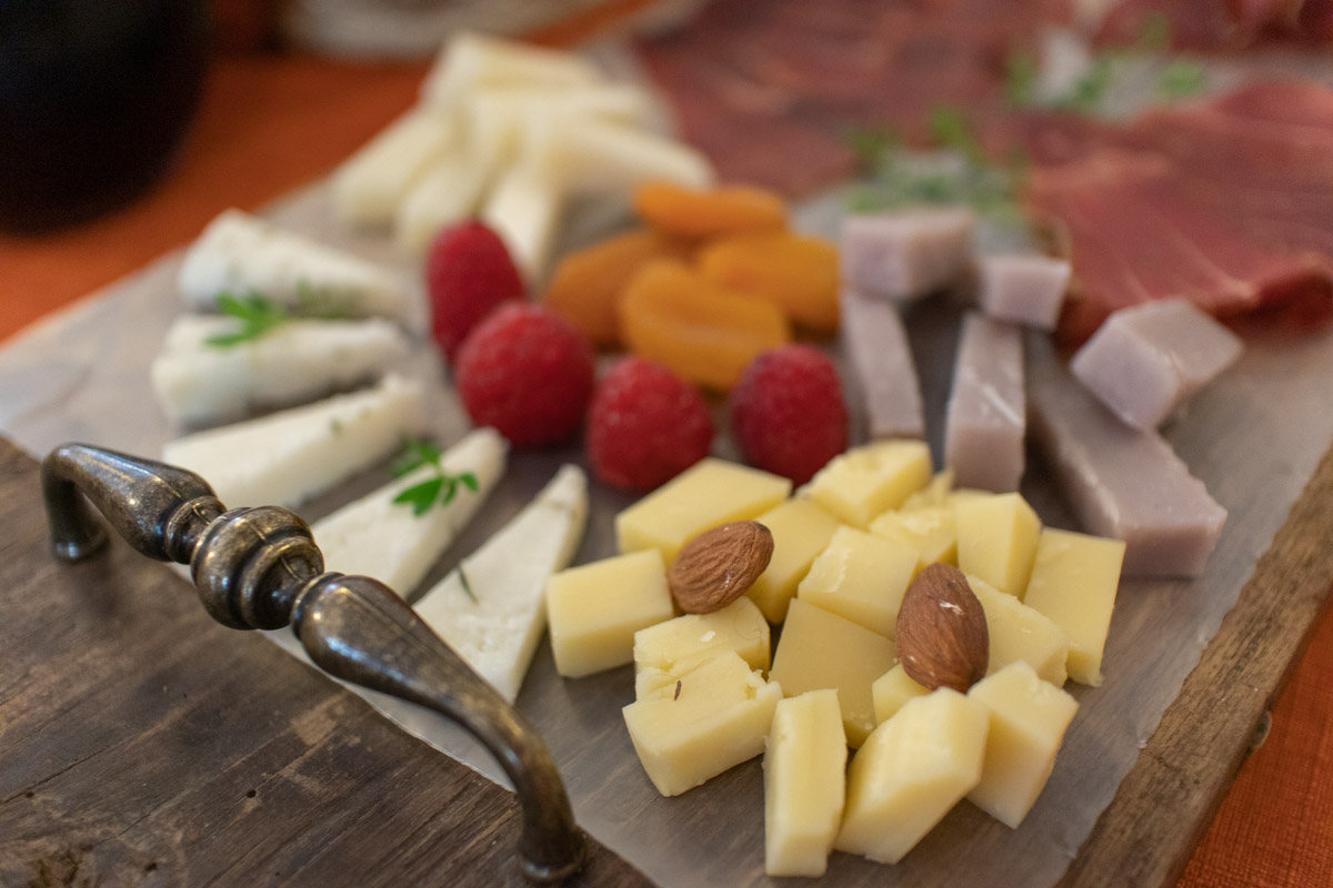 Tasting menu, cheese, nuts, and fruits shown here