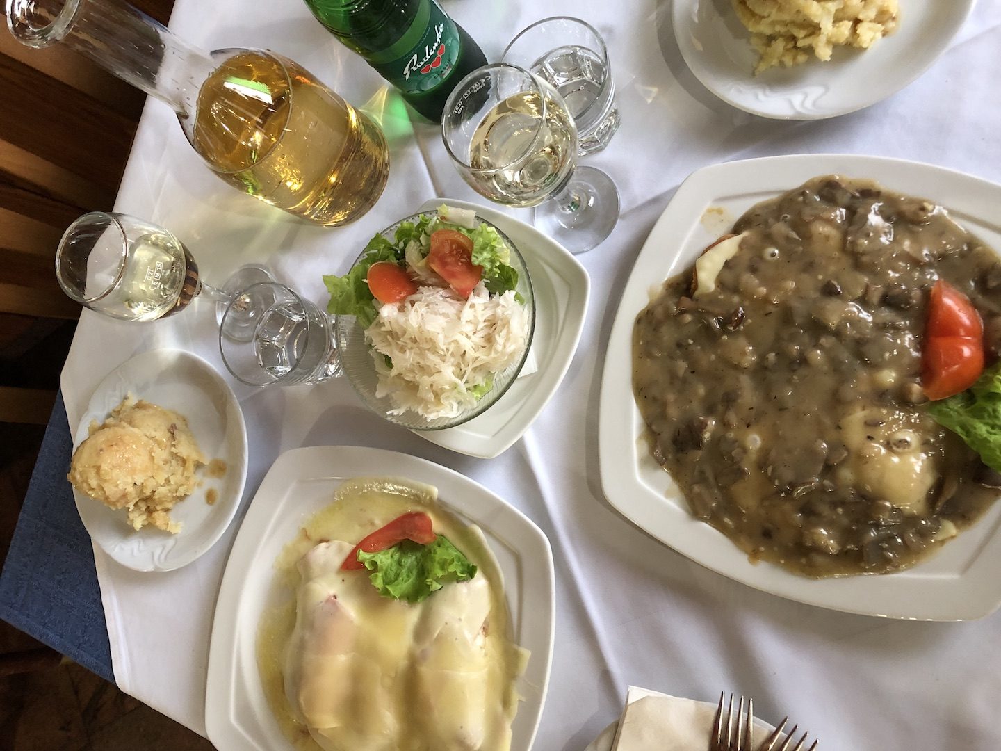 traditional slovenian meal with steaks, prazen krompir, and salad